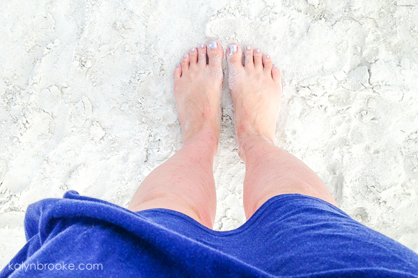 perfect beach day with feet in sand
