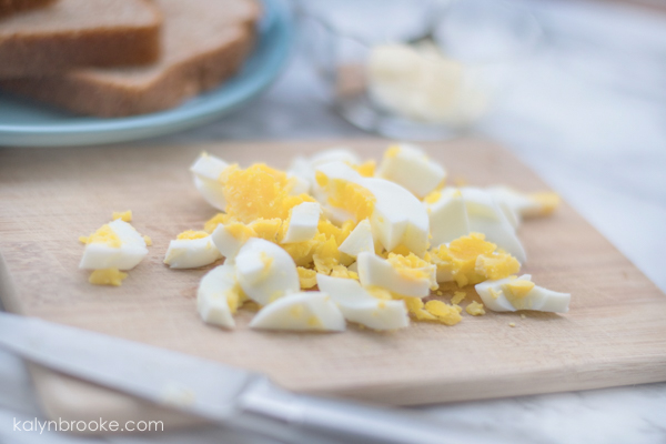 Chopped and boiled eggs on cutting board
