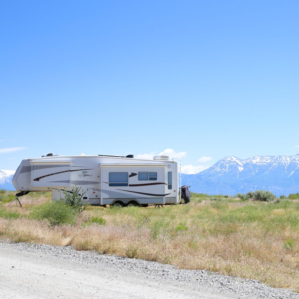 RV parked at foot of mountain range
